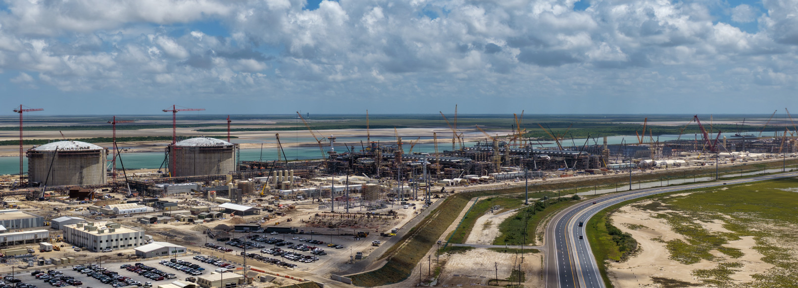 Aerial of the Rio Grande LNG construction site on the Brownsville Ship Channel. Official NextDecade still, July 2026.