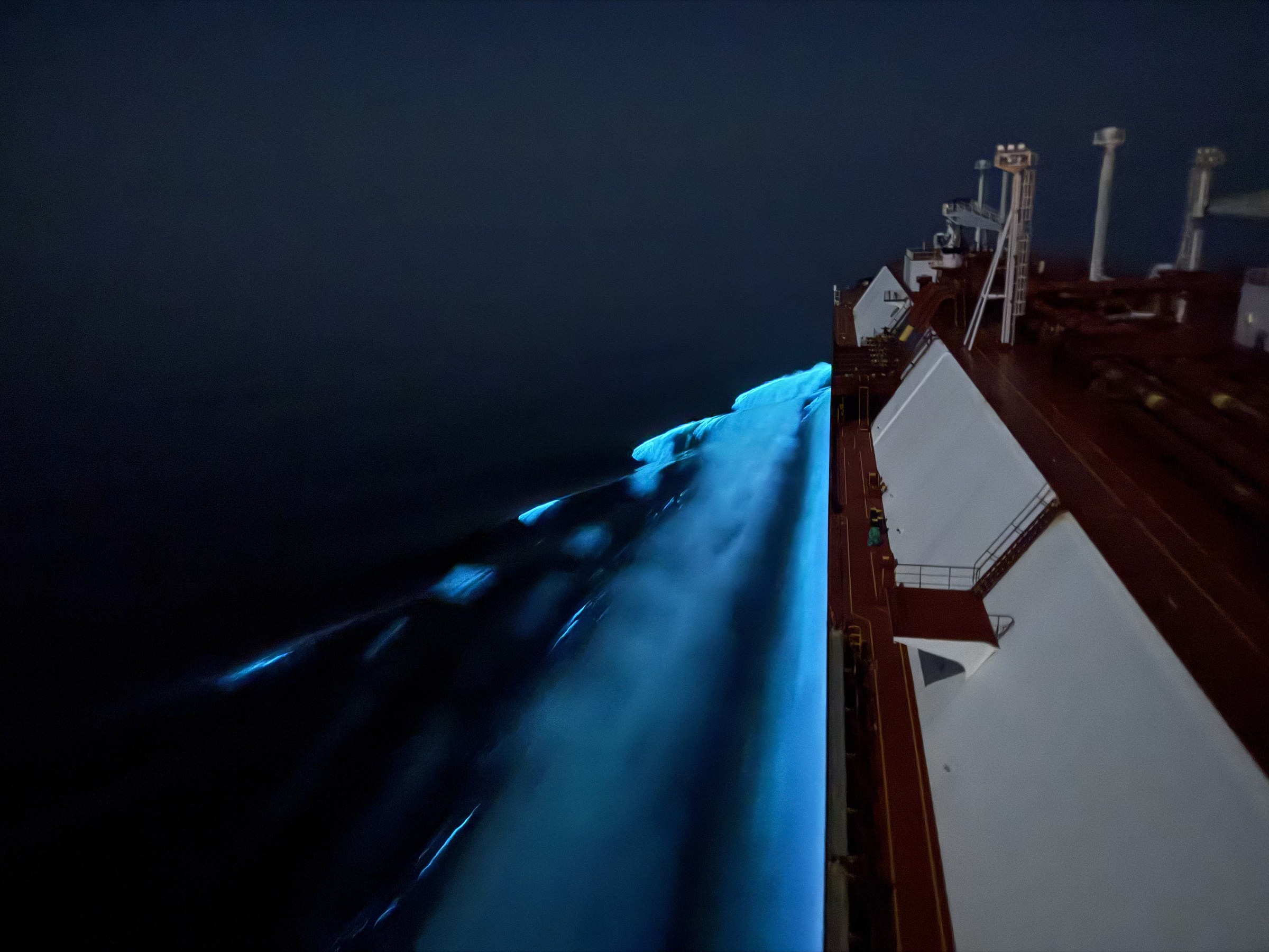 Oman coast at night, bioluminescence along the ship’s side.